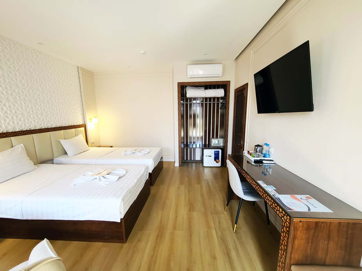 Inviting superior double room in the hotel with a double bed, desk, and TV